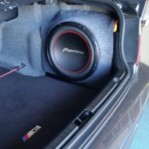 Custom side-mounted Pioneer subwoofer enclosure in trunk installation