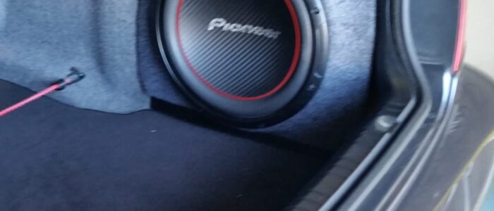 Custom Trunk Subwoofer Enclosure – OEM-Style Installation by Car Stereo Tony Custom side-mounted Pioneer subwoofer enclosure in trunk installation