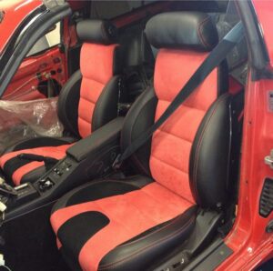 Custom red and black leather car seat upholstery installation in Orange County