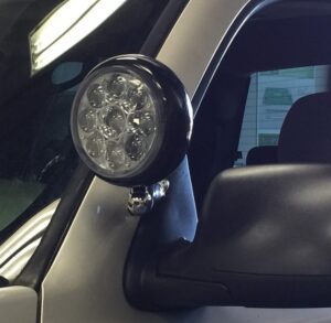 Custom auxiliary LED pod light installation on vehicle pillar in Orange County