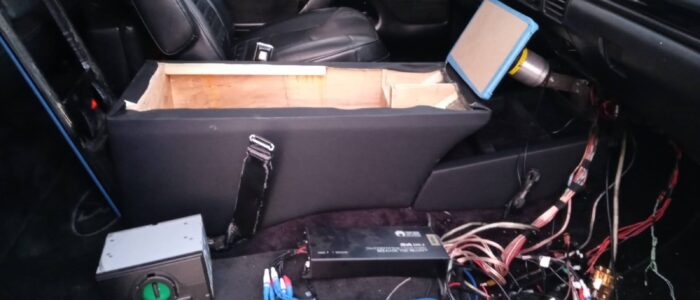 Professional Car Audio Wiring & Custom Subwoofer Build – Car Stereo Tony Custom car audio installation in progress with amplifier wiring and subwoofer enclosure fabrication in Orange County